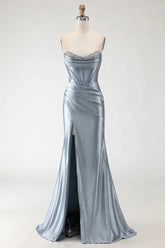 Silver evening gown on a mannequin against a white background
