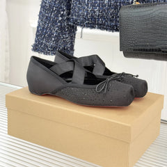 Black shoes on a beige box with a blurred background