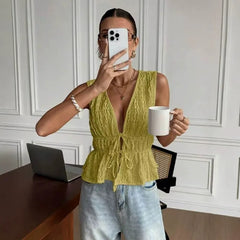 Model wearing yellow V-neck lace-up peplum top and jeans