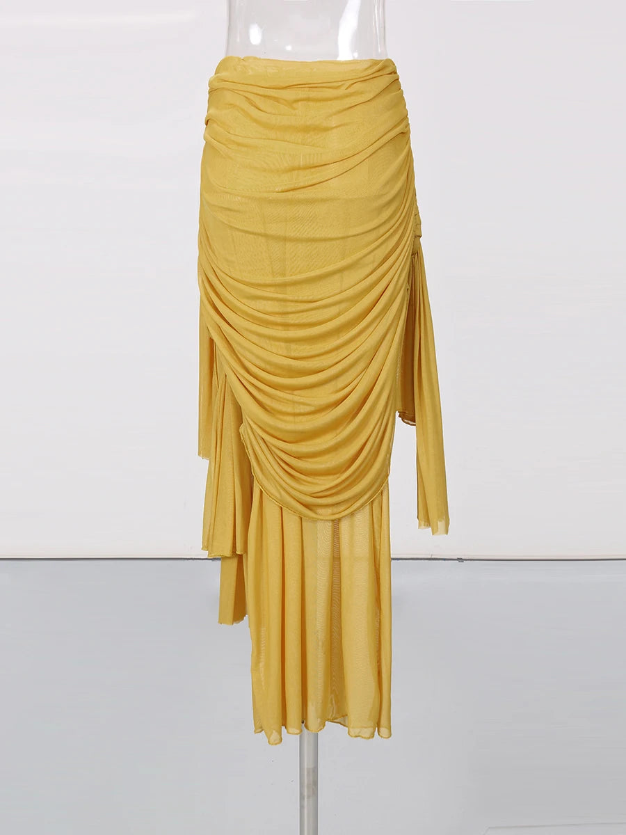Mustard yellow draped skirt on a mannequin against a white background