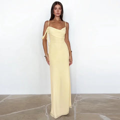Woman wearing a light yellow evening gown against a white background