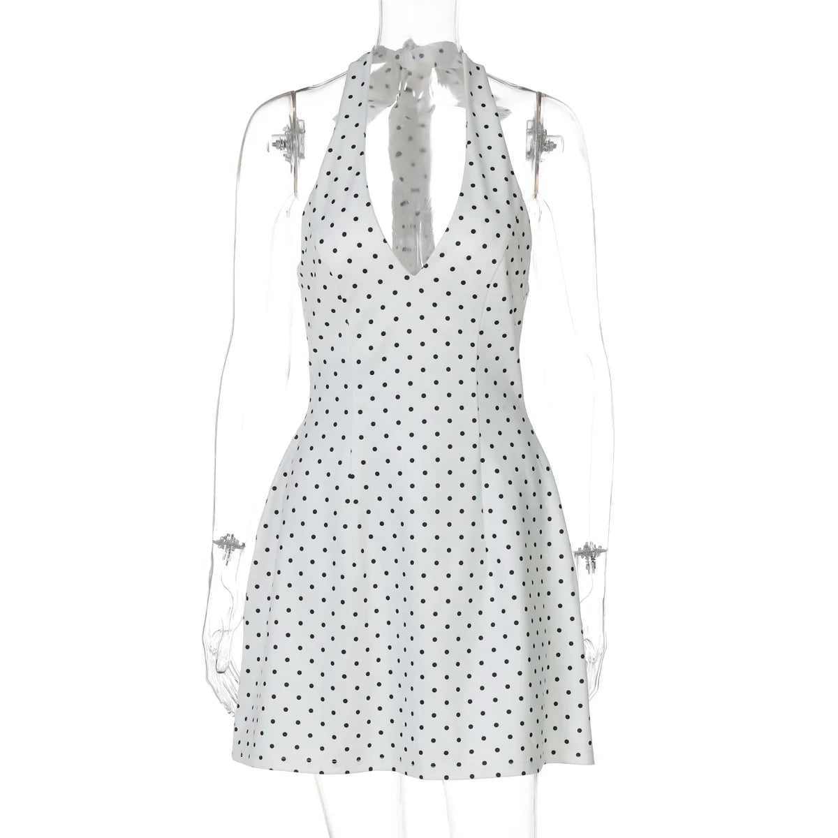 White dress with black polka dots on a mannequin against a white background