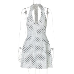White dress with black polka dots on a mannequin against a white background