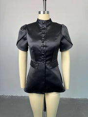 Black leather outfit on a mannequin against a gray background