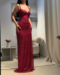 Woman wearing a burgundy sequin dress in an indoor setting