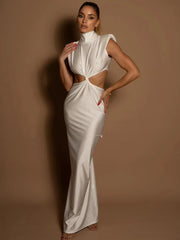 Woman wearing a white cut-out dress against a brown background