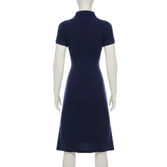 Navy blue dress on a mannequin against a white background
