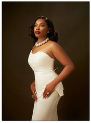 Woman in a white dress with a dark background