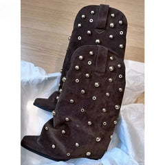 Pair of brown suede cowboy boots adorned with silver studs.