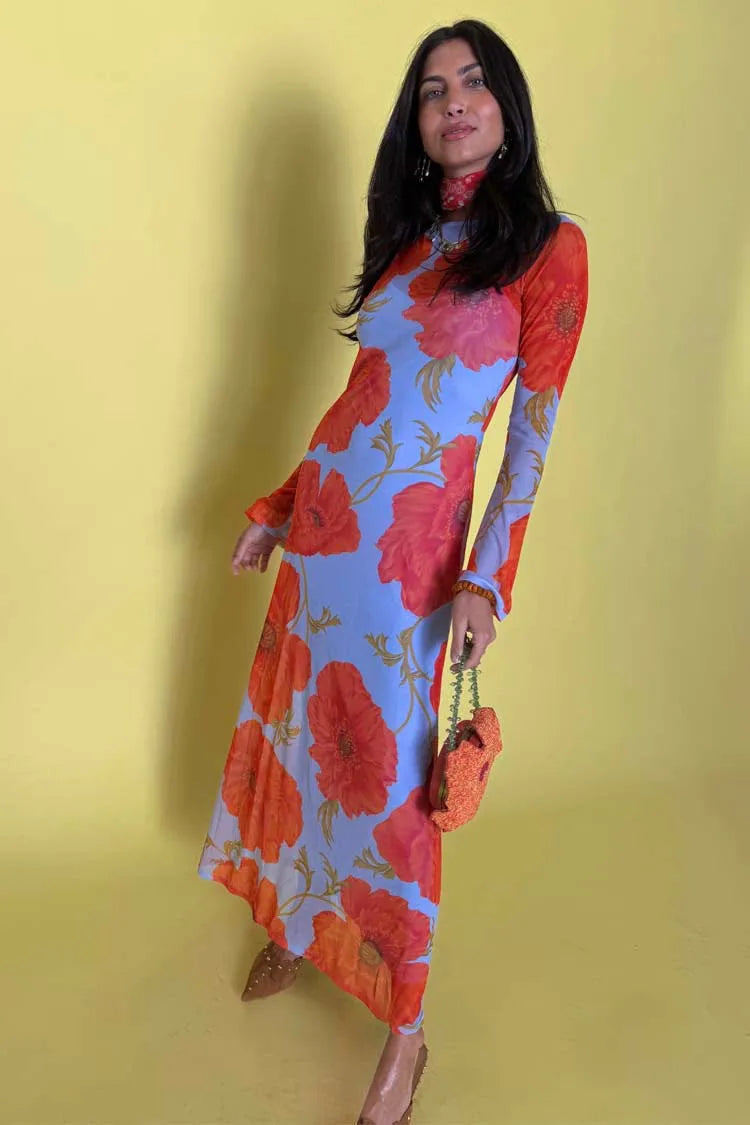 Woman wearing a colorful floral dress against a yellow background