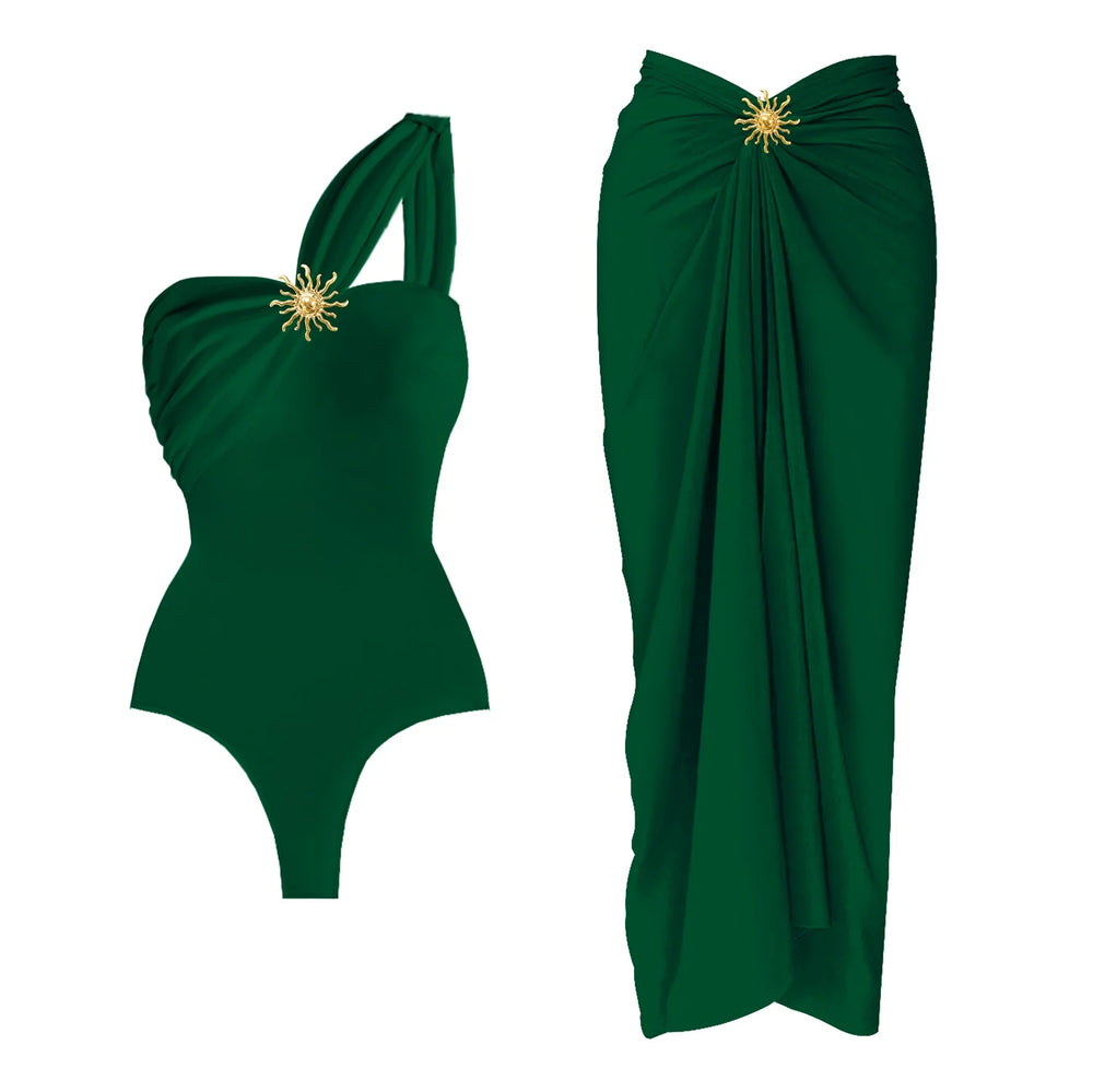 Green one-shoulder draped bodysuit and wrap skirt set with sunburst embellishment