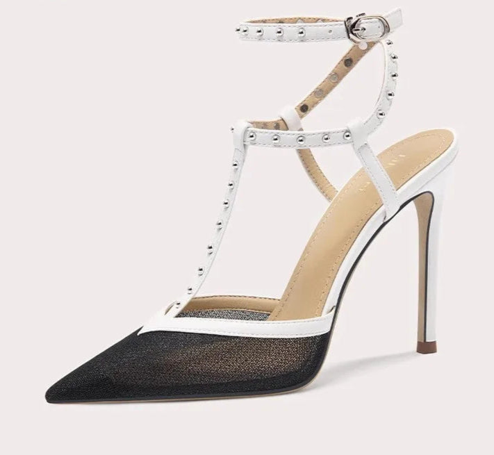High-heeled shoe with studded details on a white background