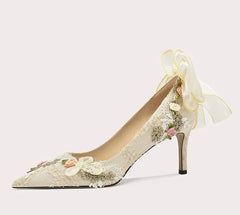 High-heeled shoe with floral design on a light gray background