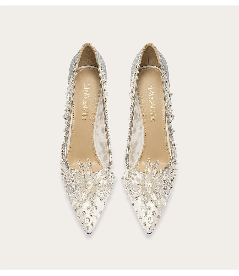 Pair of silver embellished shoes on a white background