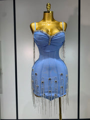 Blue dress with fringe details on a mannequin against a neutral background