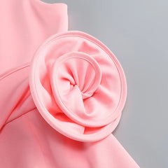 Close-up of a pink fabric flower on a pink fabric background