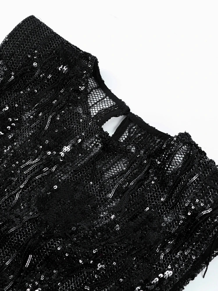 Black sequined garment on a white background