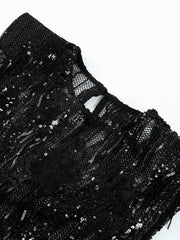 Black sequined garment on a white background