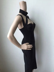 Black dress on a mannequin against a plain background