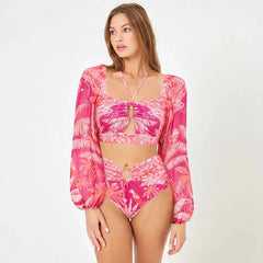 Model wearing tropical print long sleeve crop top and high waist briefs swimwear