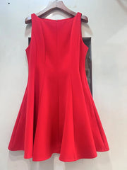 Red dress on a hanger against a white wall