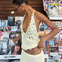 Fashionable woman posing in a sequin knit halter crop top and maxi skirt.
