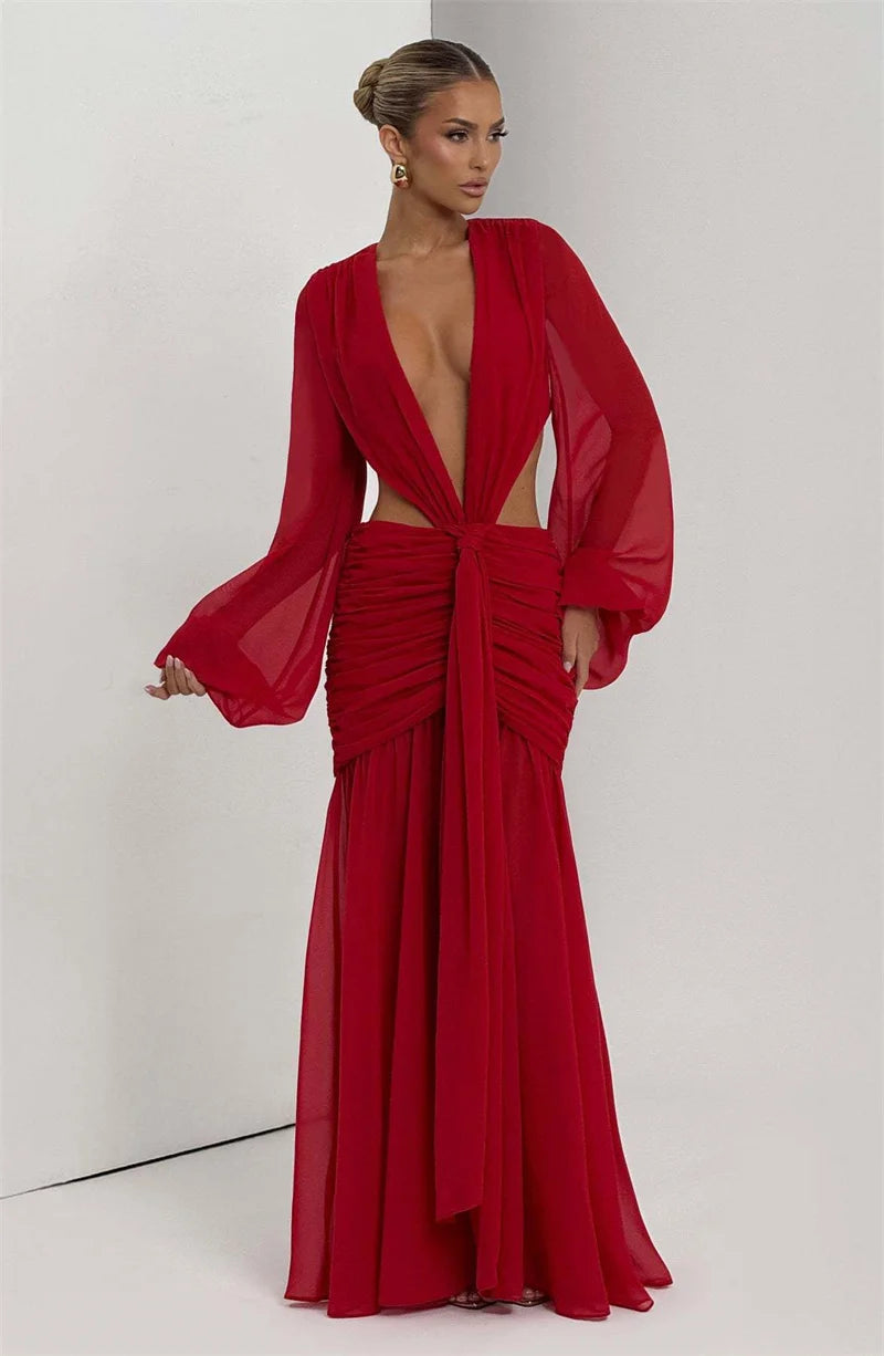 Woman wearing a red evening gown with a plunging neckline on a white background