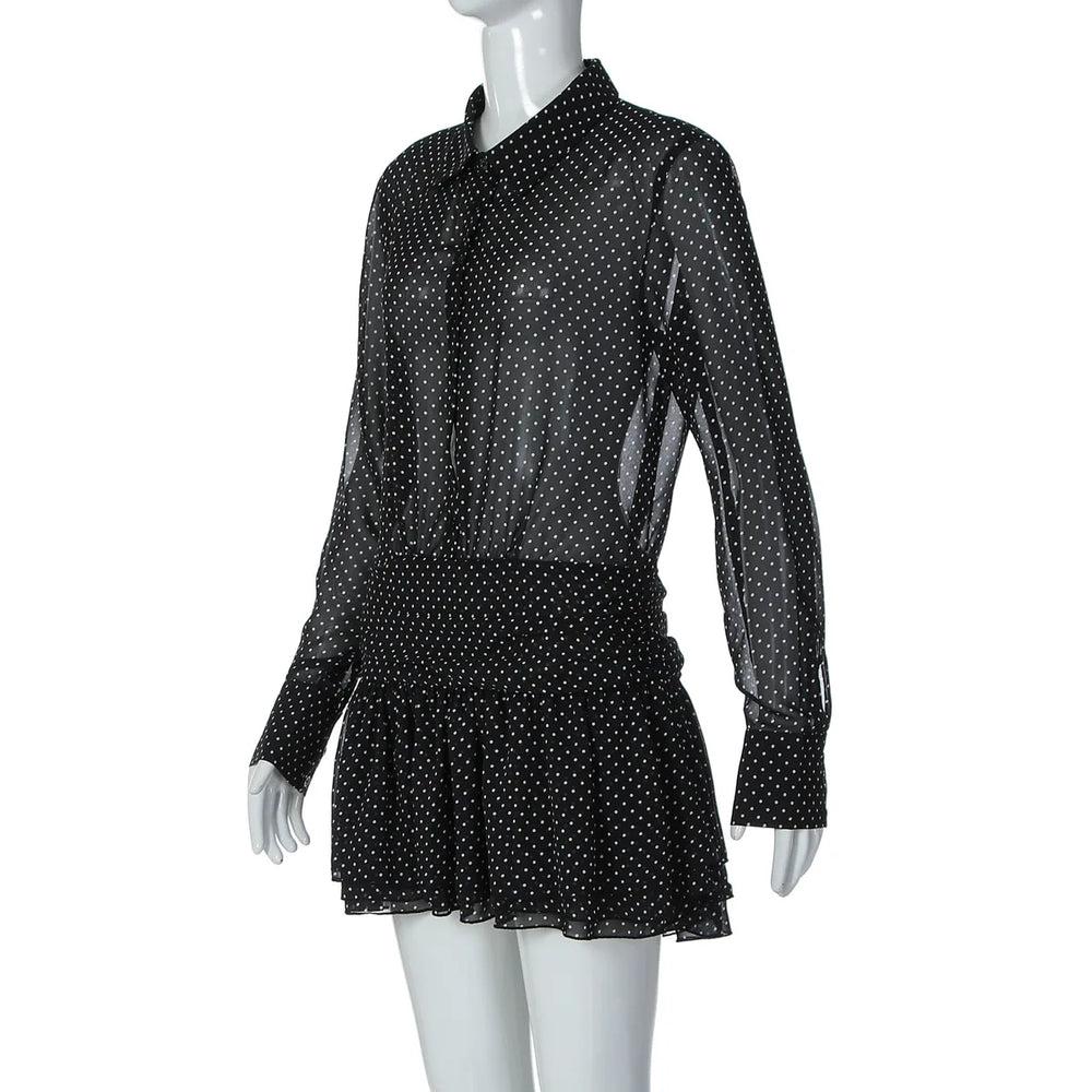 Black polka dot dress on a mannequin against a white background