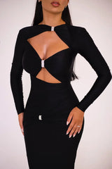 Black dress with cut-out design on a plain background