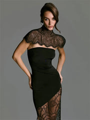 Woman wearing a black dress with lace detailing on a gray background