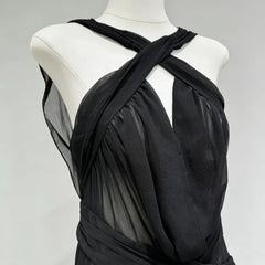 Black dress on a mannequin against a gray background