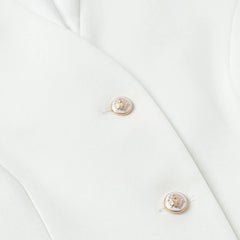 Gold earrings on a white fabric background