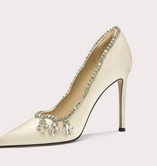 High-heeled shoe with decorative elements on a light gray background