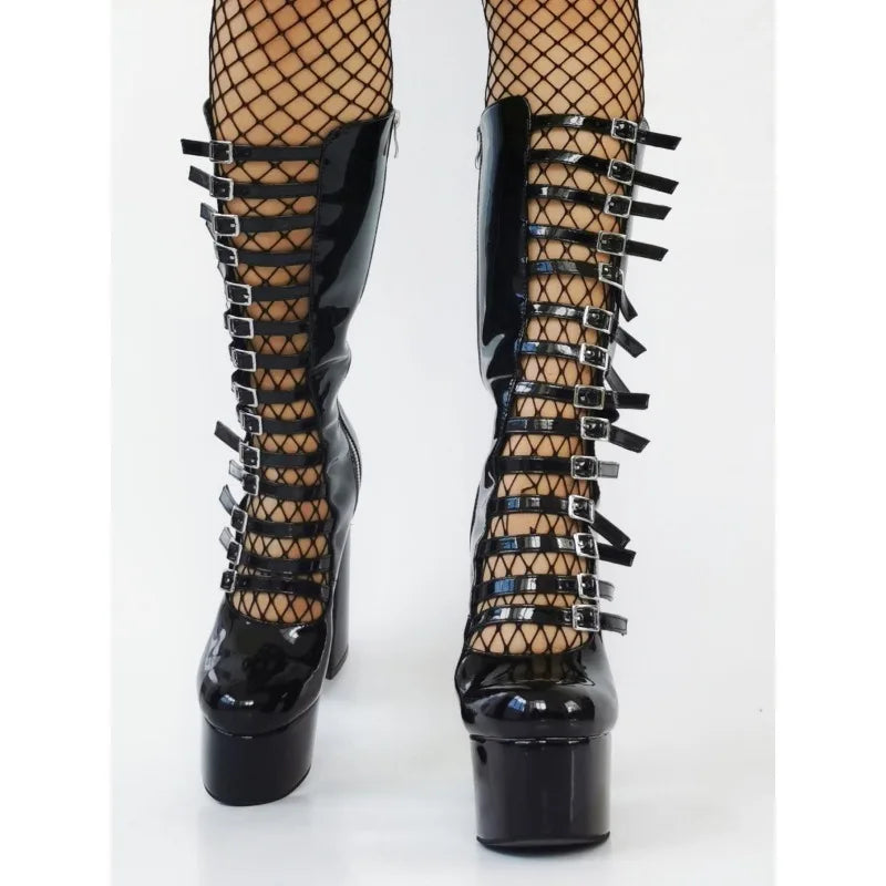 Black high-heeled boots with studded details on a white background