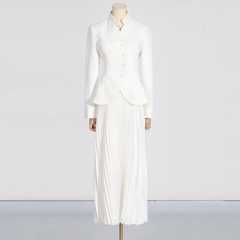 Mannequin wearing a white outfit with a jacket and pleated skirt on a plain background