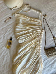Gold dress with accessories on a textured surface