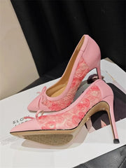 Pink high-heeled shoes with lace details on a magazine