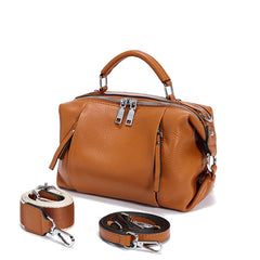 Brown leather handbag with detachable straps on a white background.