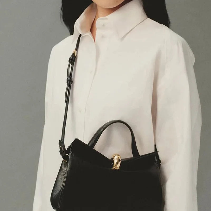 Close-up of a woman with a black shoulder bag