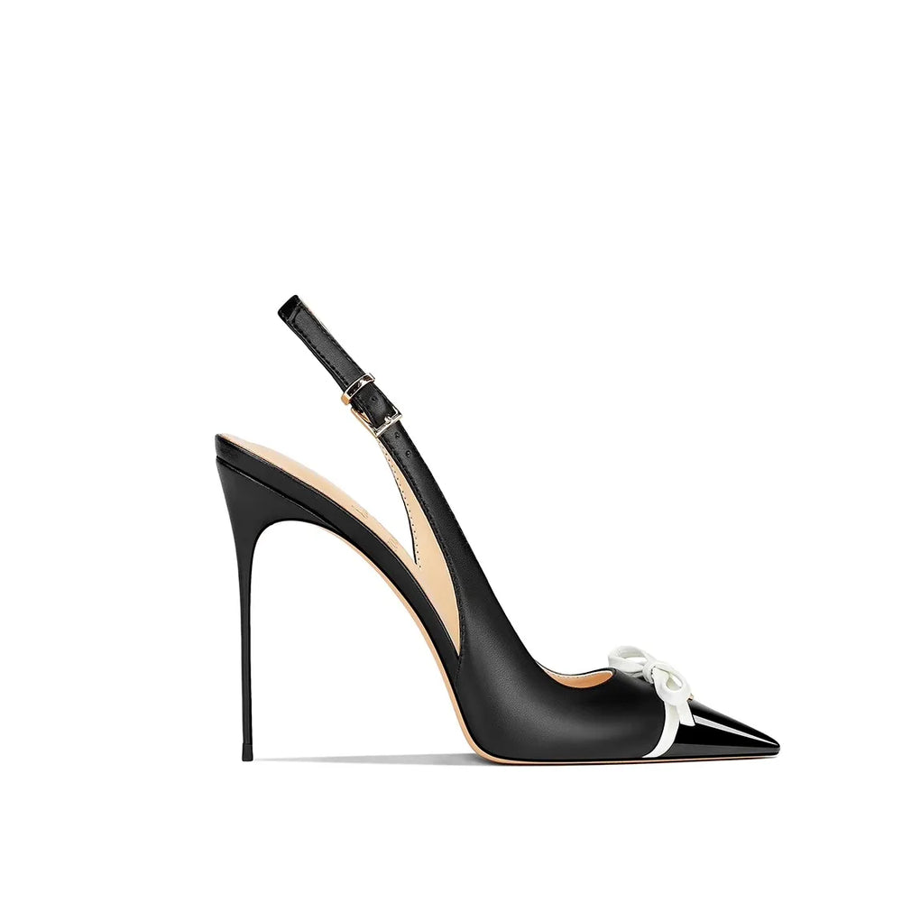 Black high-heeled shoe with a white bow on a white background