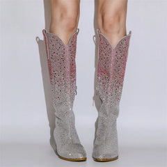 Silver glittery cowboy boots on a white background