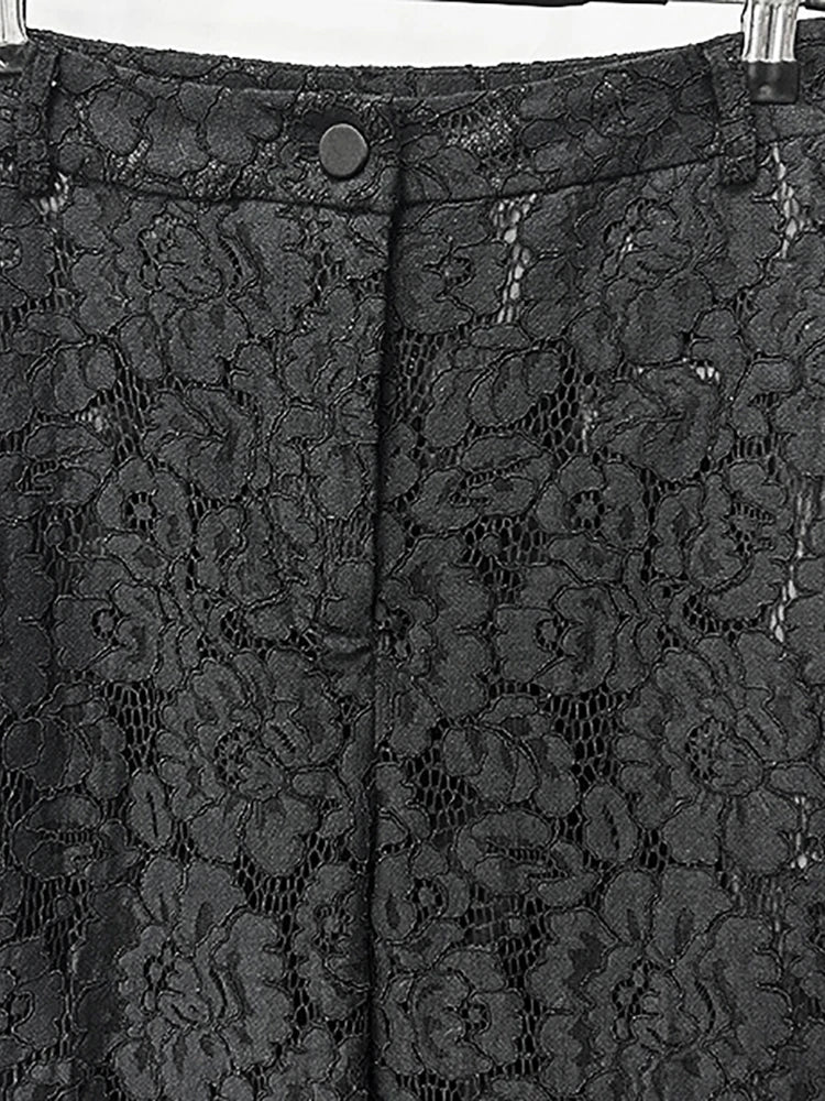 Black lace fabric with floral patterns on a plain background