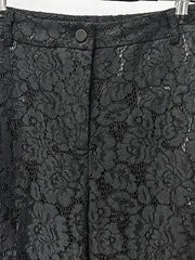 Black lace fabric with floral patterns on a plain background