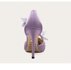 Purple high-heeled shoe with floral details on a white background