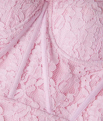 Close-up of pink lace fabric with a subtle pattern