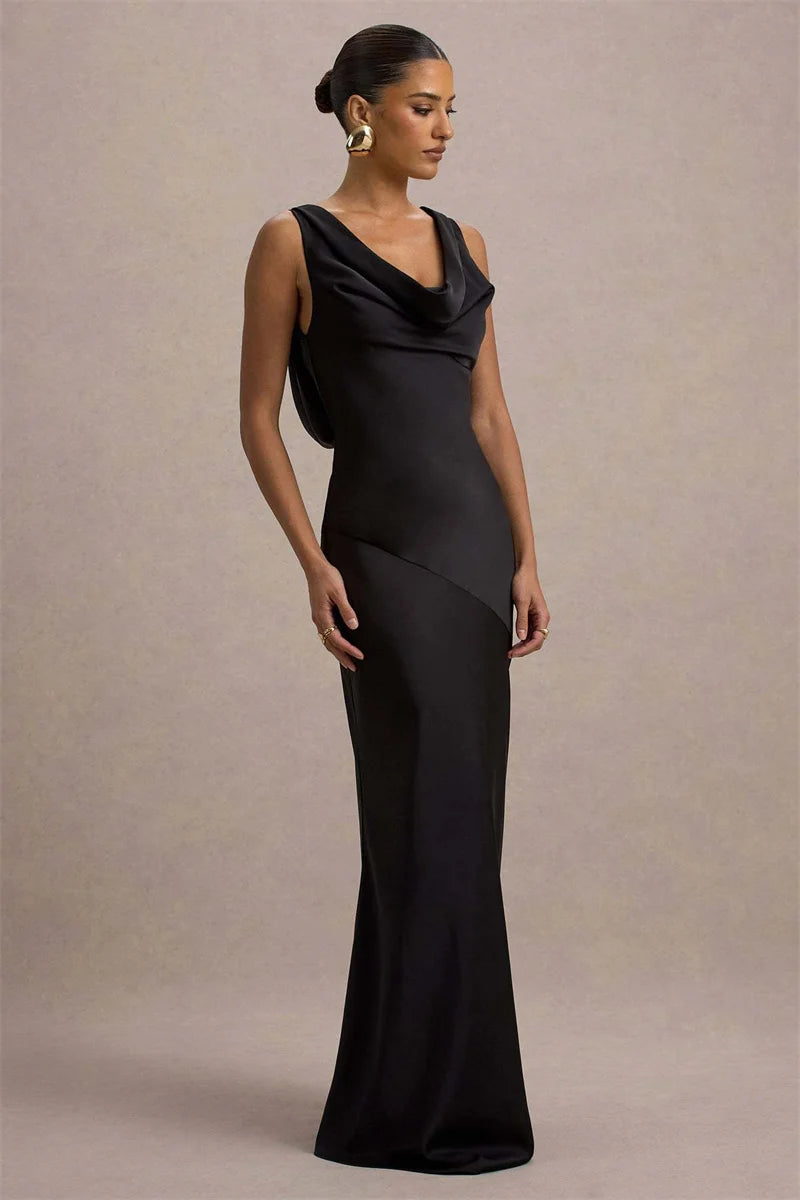 Woman wearing a black evening gown against a beige background