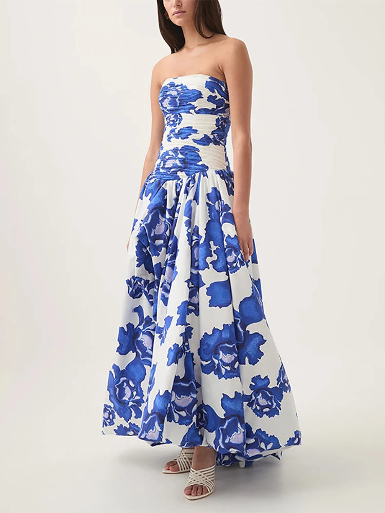 Woman wearing a strapless blue floral dress on a white background