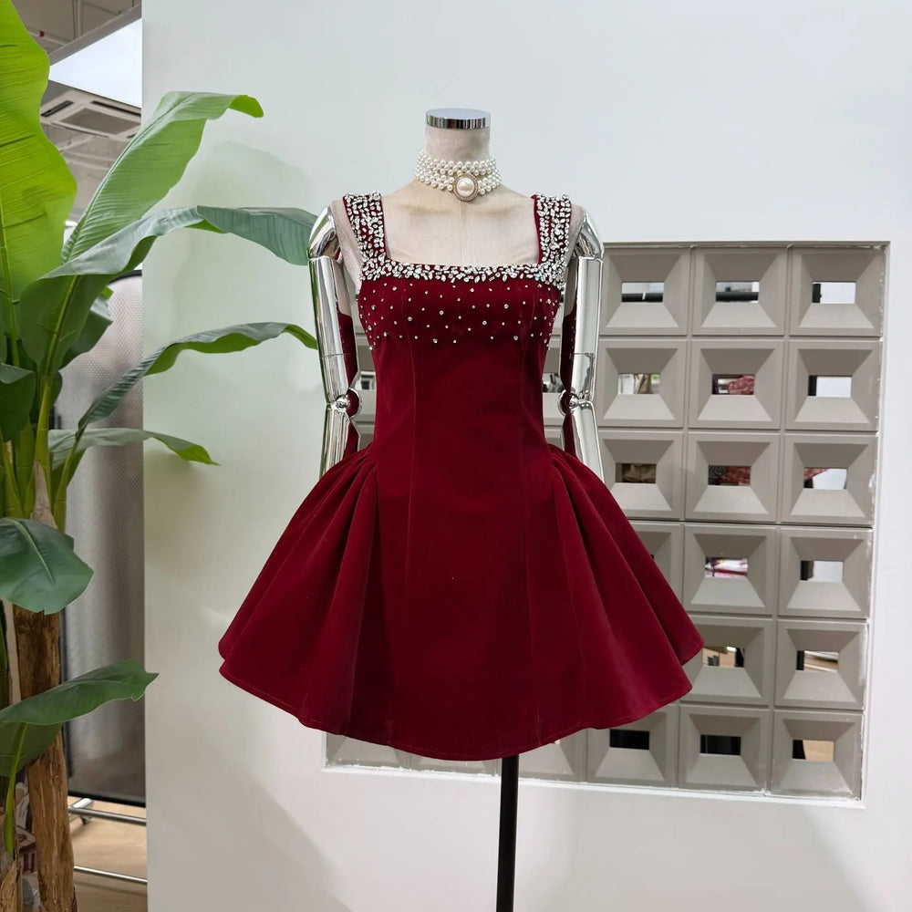Red dress on a mannequin against a geometric wall pattern