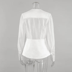 White blouse on a mannequin against a gray background