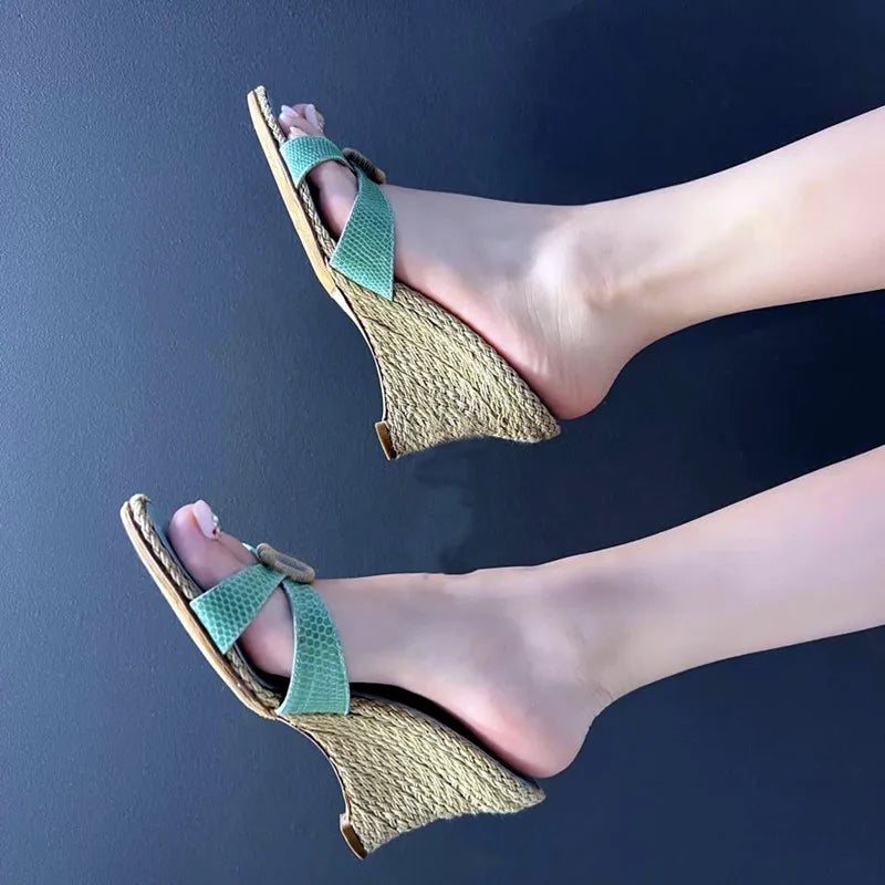 Feet wearing woven wedge heeled sandals